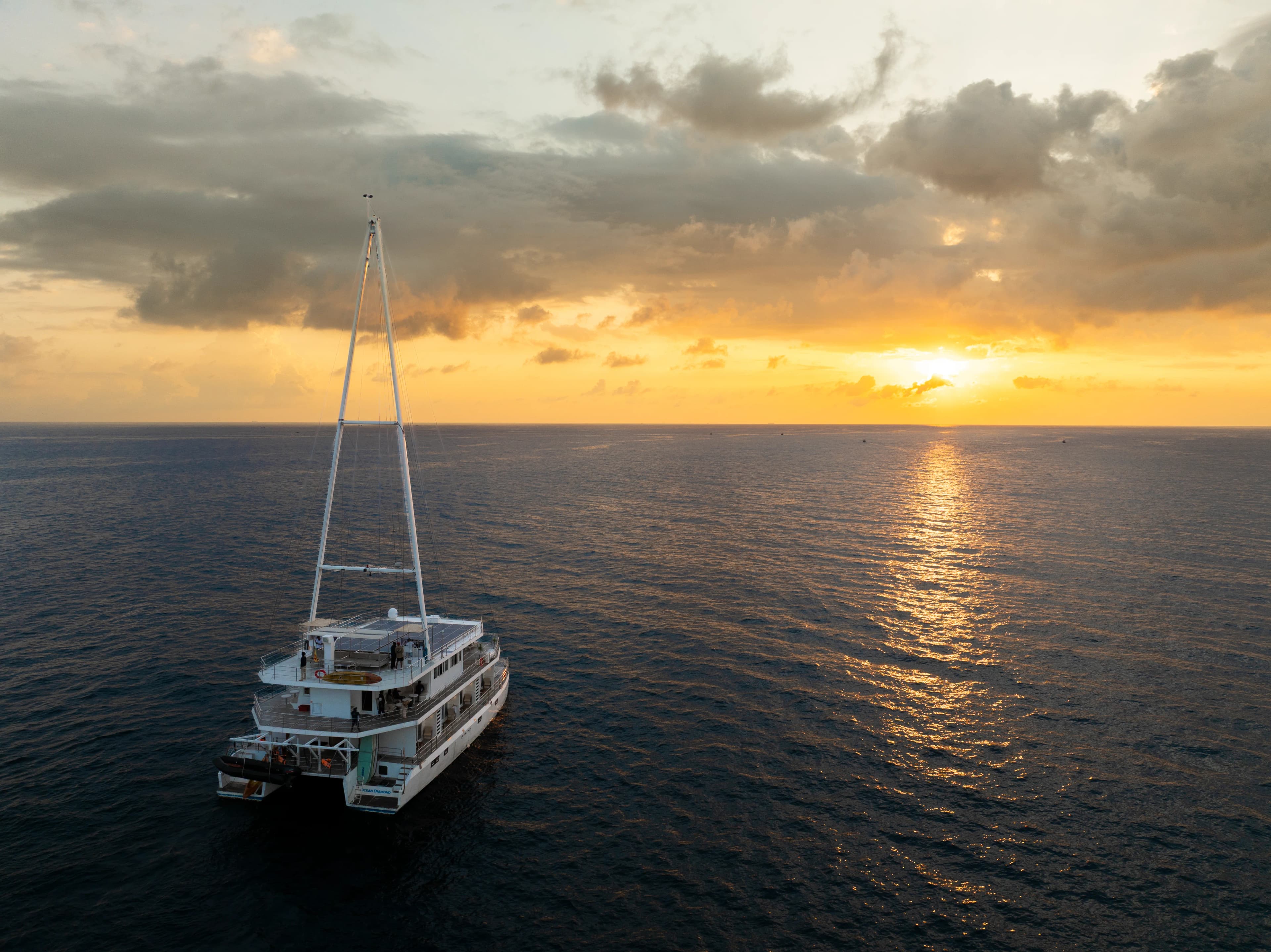 A Sail Lanka catamaran anchored off Sri Lanka's southern coast at golden hour